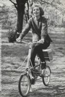 period photo of fashionable woman on small wheeler