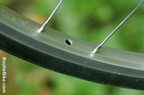 close up of section of wheel rim fitted with airless tyre showing unused valve hole