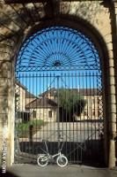 stella poketby in front of large ornate old gates in sandstone archway