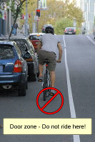 silly cyclist riding in door zone